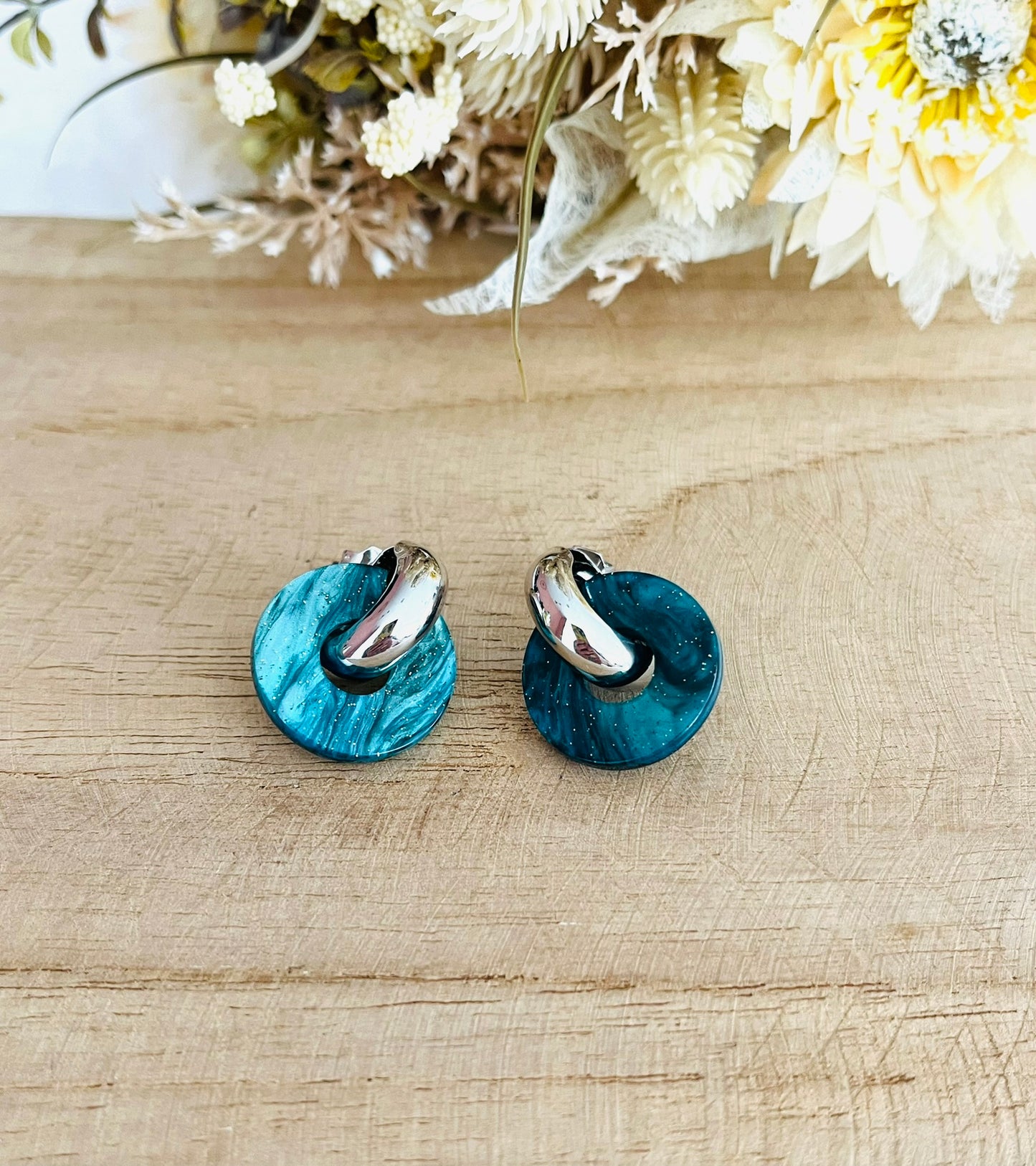 Boucles d'oreilles à clous style créoles bombées dorées.
Pendentifs donut en acrylique.
Boucles d'oreilles fantaisie fait main.