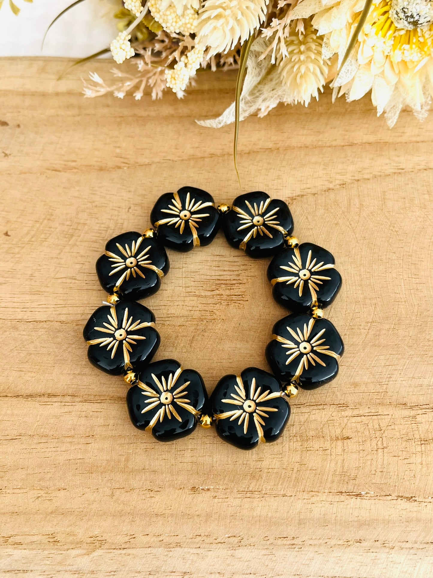Bracelet élastique en perle acrylique fait main.
Perles en forme de fleur noir et doré.
Bijou fantaisie fait main.