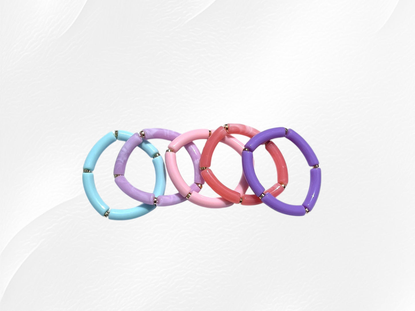 Bracelet pour enfant monté sur élastique.
Perles en acrylique de différentes couleurs et petites perles intercalaires dorées en plastique
