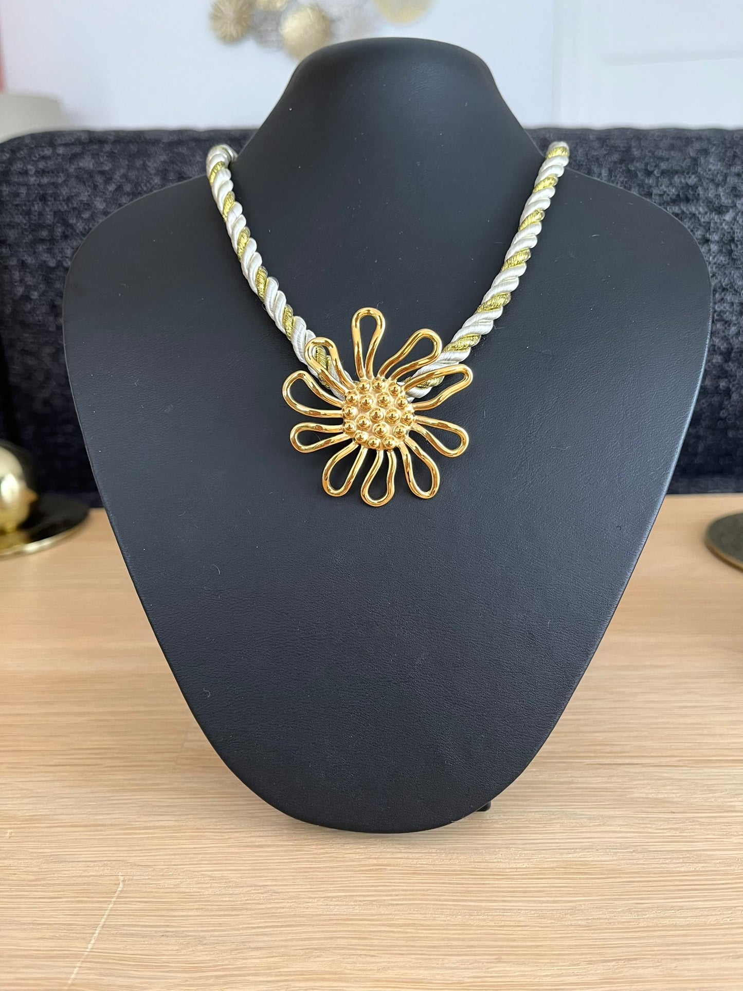 Collier corde tressée écru
et doré avec pendentif fleur en acier inoxydable doré.
Bijou fantaisie fait main.