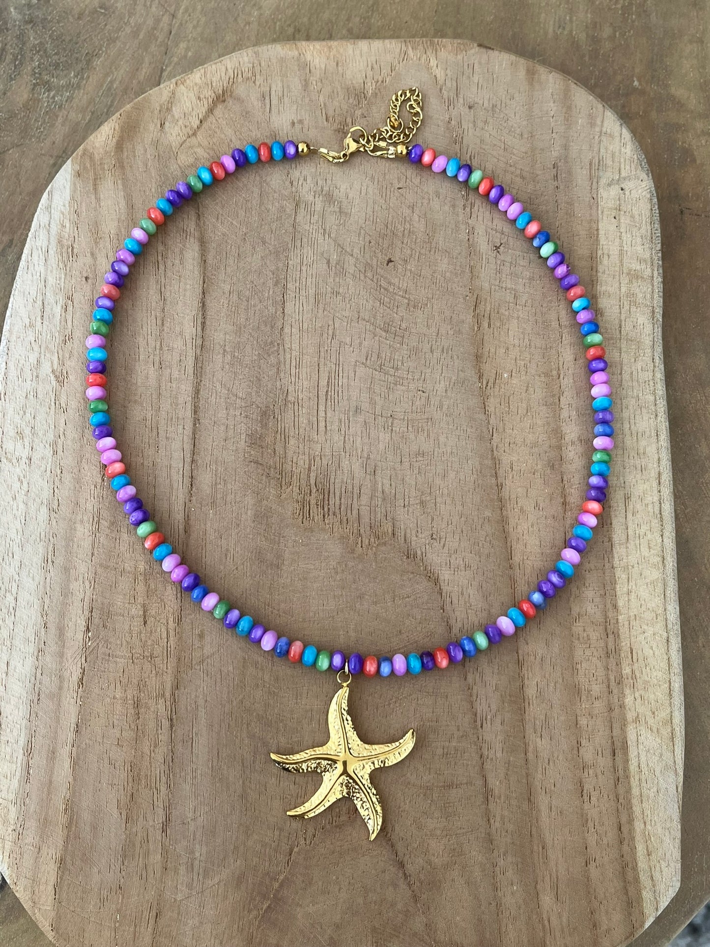 Collier fantaisie fait main.
Perles en coquillage violet multicolore, pendentif coquillage en acier inoxydable doré.
Bijou fantaisie fait main.
