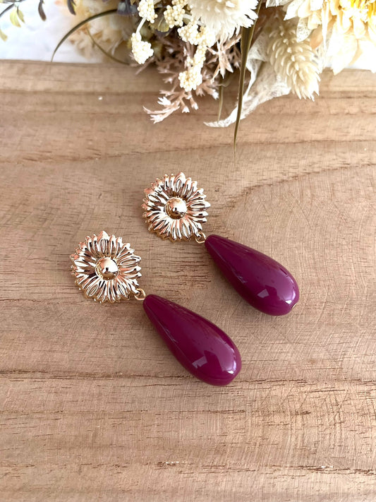 Boucles d'oreilles fantaisie fait main.
Clous d'oreilles fleur en laiton doré.
Perles goutte en résine prune.
Bijou artisanal fait main.