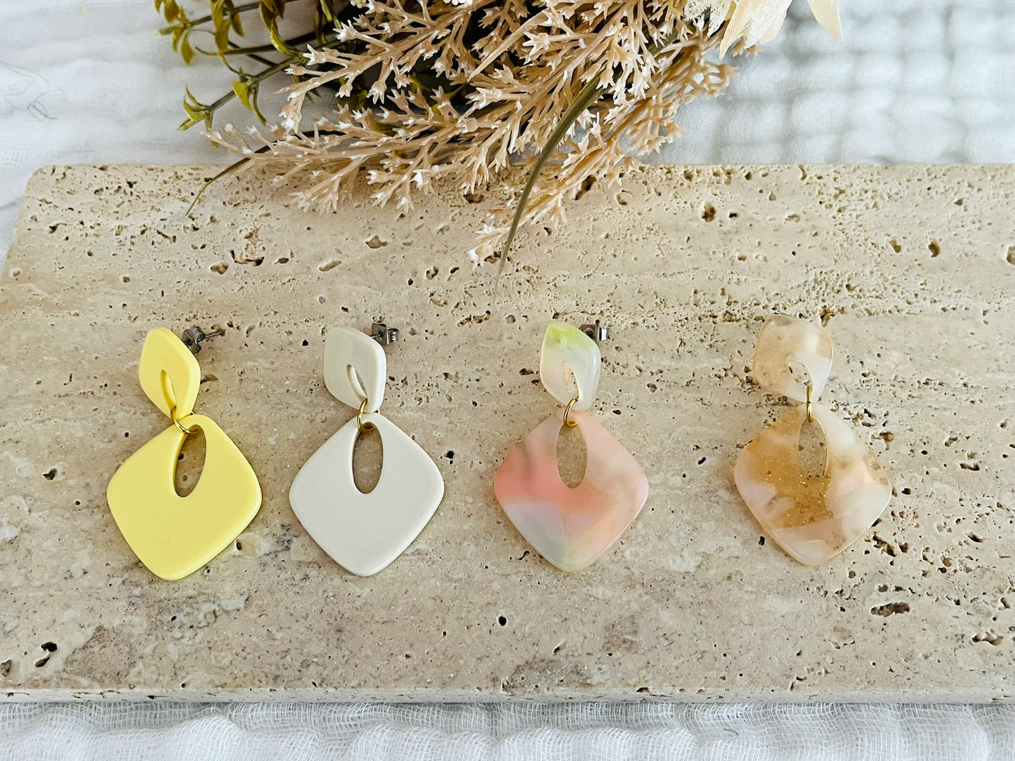 Boucles d'oreilles fantaisie fait main.
Clous d'oreilles losange en acrylique.
Pendentif losange évidé en acrylique.
4 couleurs: jaune, ivoire, marbré corail, marbré pêche nacré pailleté.
Bijou fantaisie fait main.
