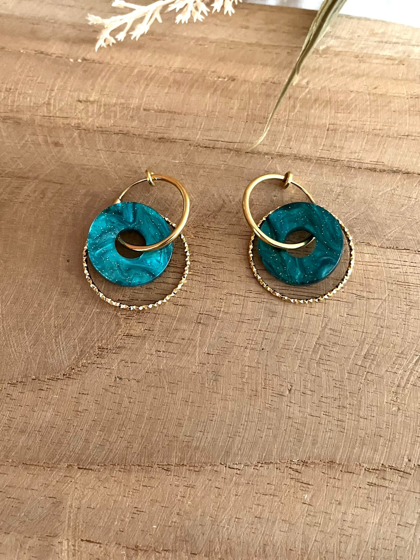Boucles d'oreilles créoles en acier inoxydable doré pour oreilles non percées.
Pendentif donut en acrylique vert pailleté.
Bijou fantaisie fait main.