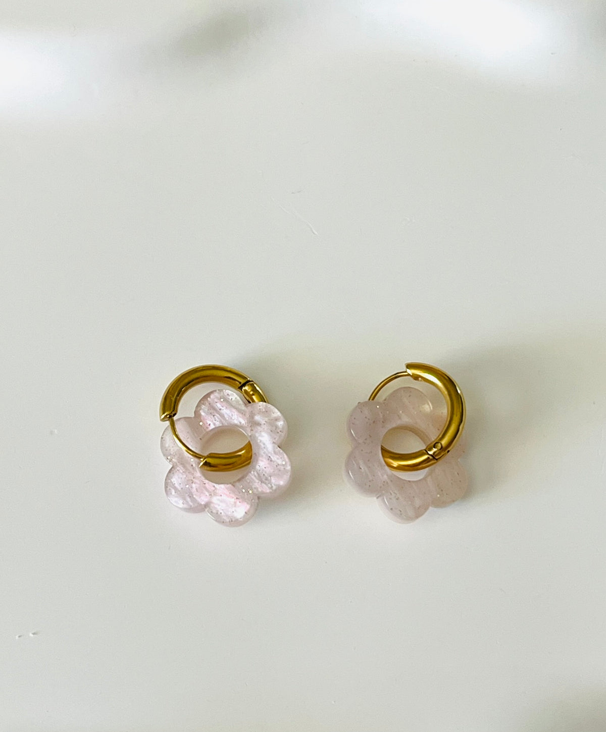 Boucles d'oreilles créoles adaptées pour les enfants à partir de 6 ans.
Créoles en acier inoxydable doré de 15mm.
Petites fleurs blanc et lilas avec paillettes en acrylique.
