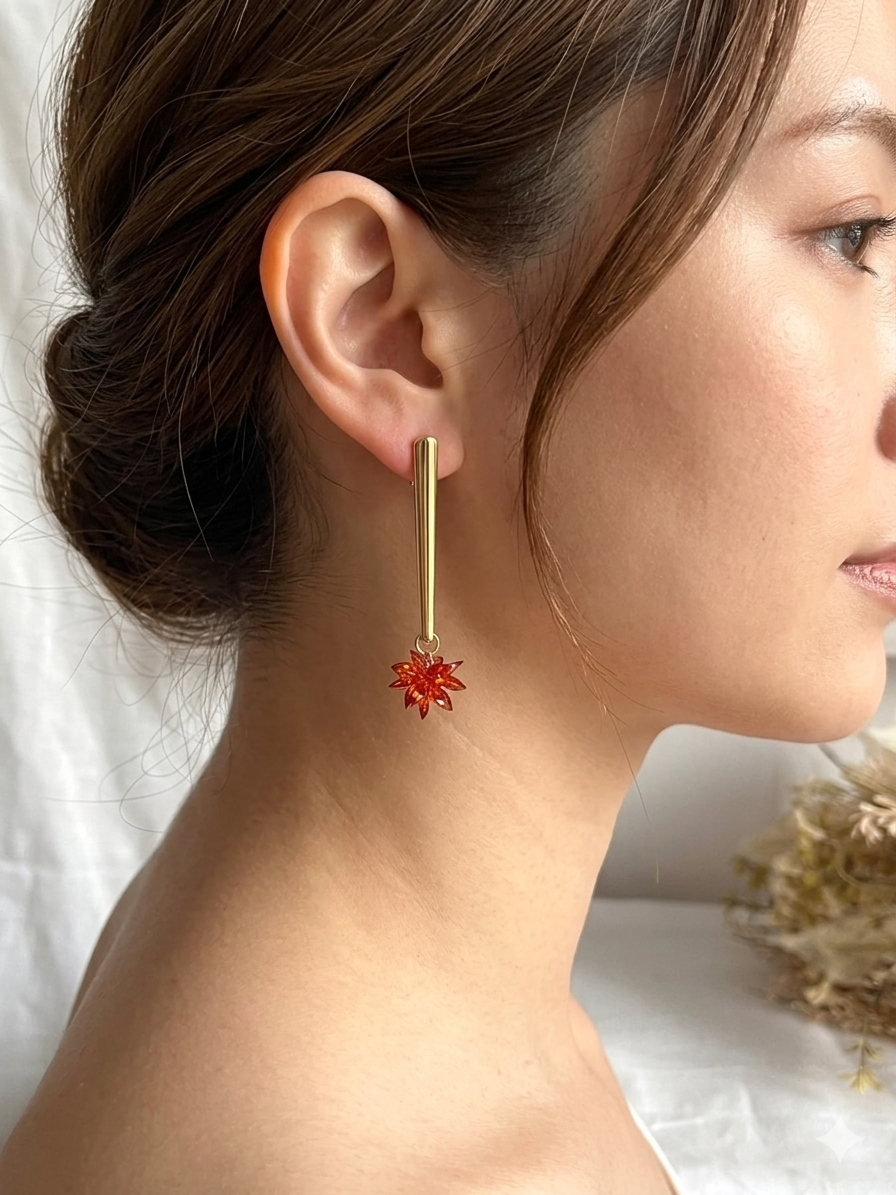 Boucles d'oreilles fantaisie fait main.
Clous d'oreilles longue barre en acier inoxydable doré. Pendentif fleur étoilée en verre cristal de couleur rouille.
Bijou fantaisie fait main.