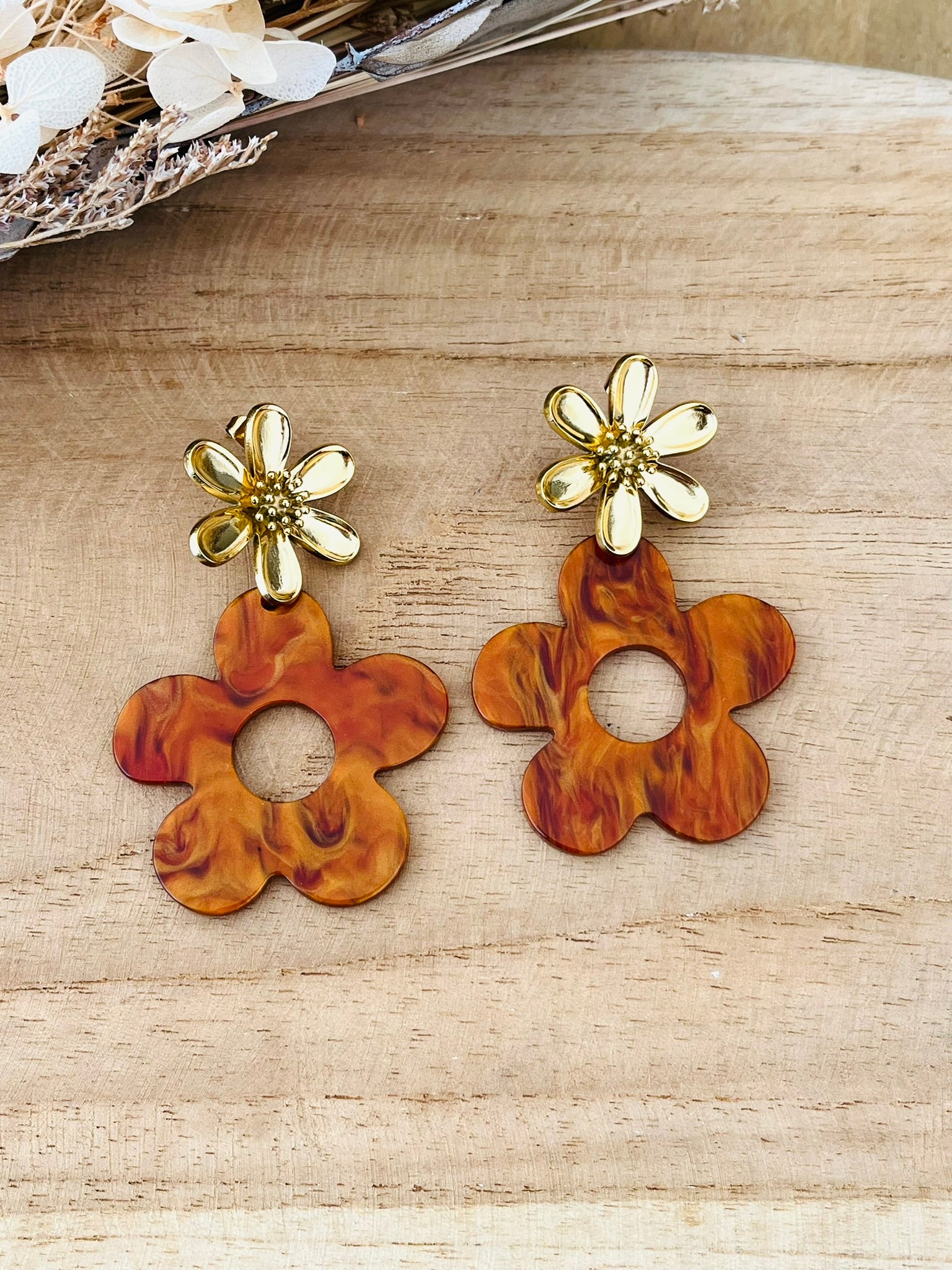 Boucles d'oreilles fantaisie à clous faites main.
Clous d'oreilles fleur en acier inoxydable doré.
Pendentifs fleur en acrylique marron topaze.
Bijou fantaisie fait main.