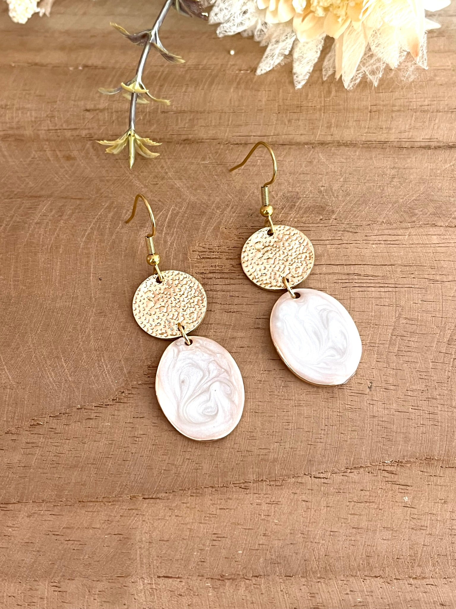 Boucles d'oreilles fantaisie fait main.
Crochets en acier inoxydable, connecteurs ronds doré, pendentifs ovales doré et émaillés blanc nacré.
Bijou fantaisie fait main.