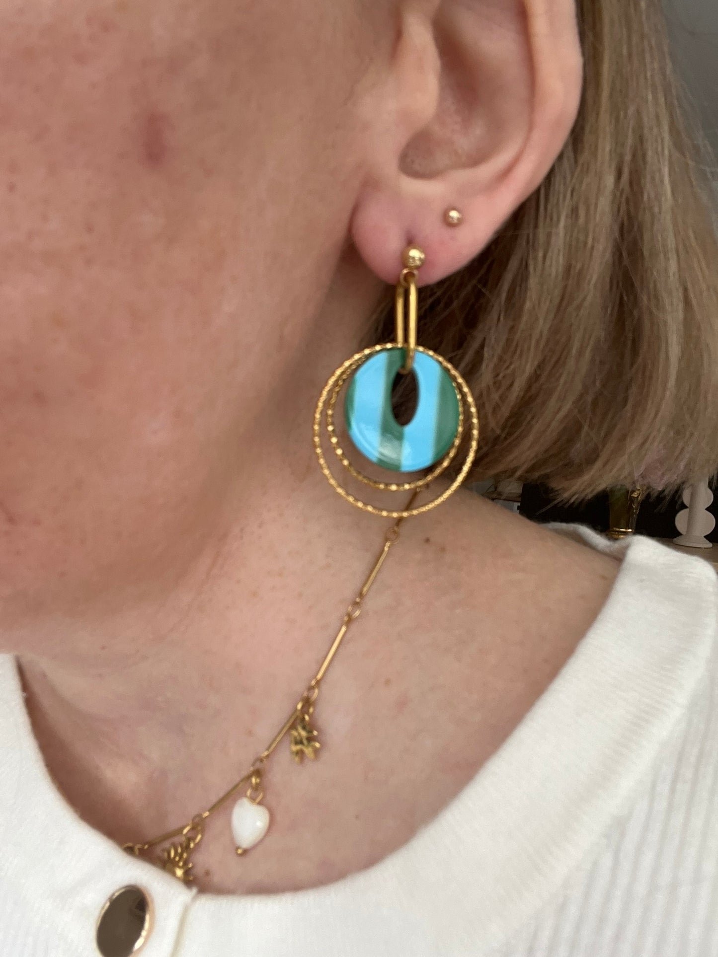 Boucles d'oreilles fantaisie fait main.
Clous d'oreilles en acier doré.
Jeu d'anneaux ciselés de 25 et 30mm en acier doré.
Pendentifs ronds en acrylique rayés bleu et vert.
Bijou fantaisie fait main.