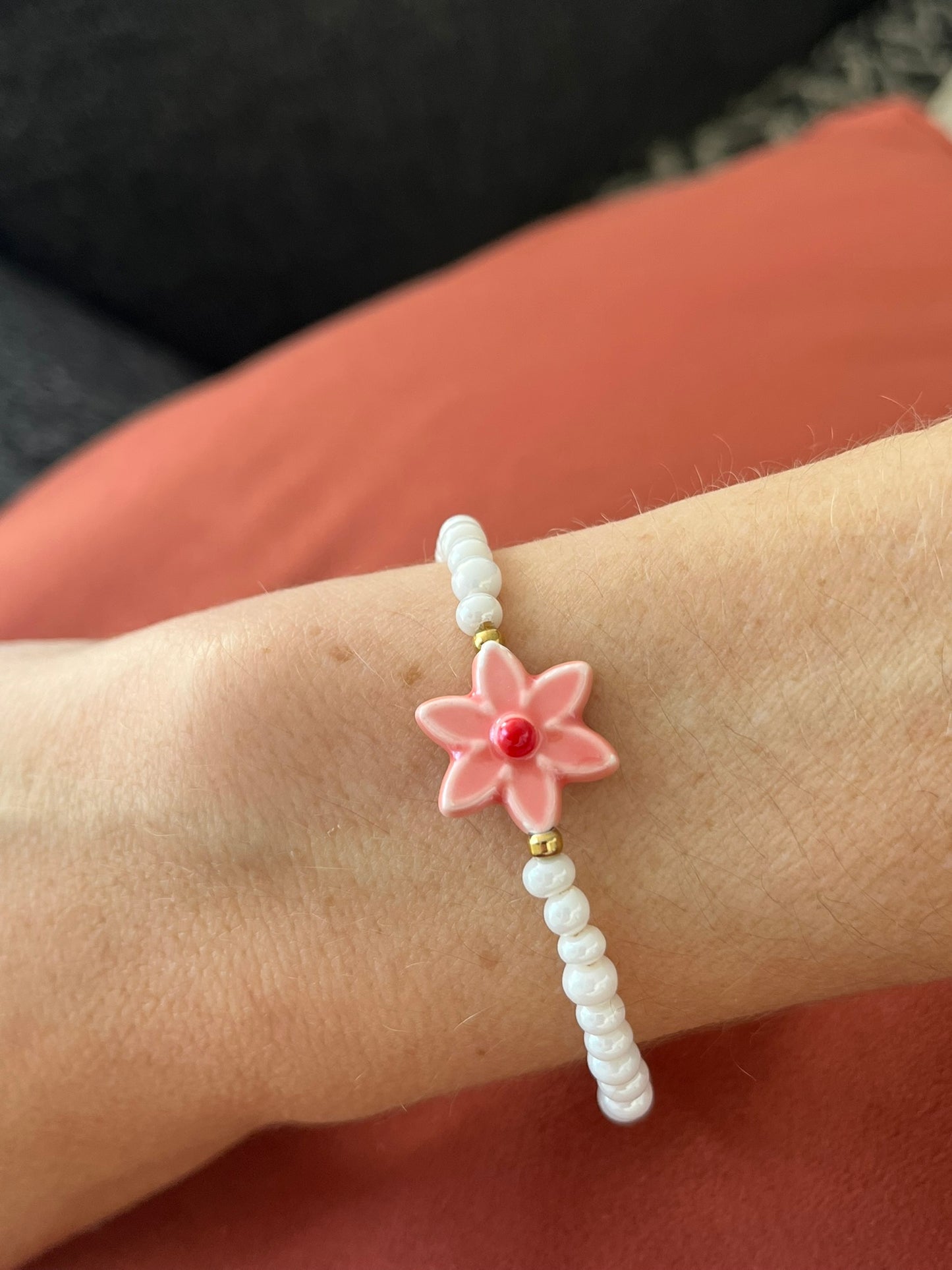 Bracelet fantaisie fait main.
Perles en verre blanc nacré, perle fleur en céramique rose.
Fermoir en acier inox doré.
Bijou fait main.