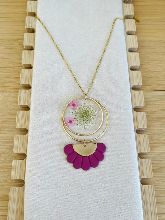 Collier fantaisie fait main.
Chaine fine en acier inoxydable doré; pendentif rond en résine avec fleurs séchées rose; pendentif demi-fleur rose framboise.
Bijou fantaisie fait main.